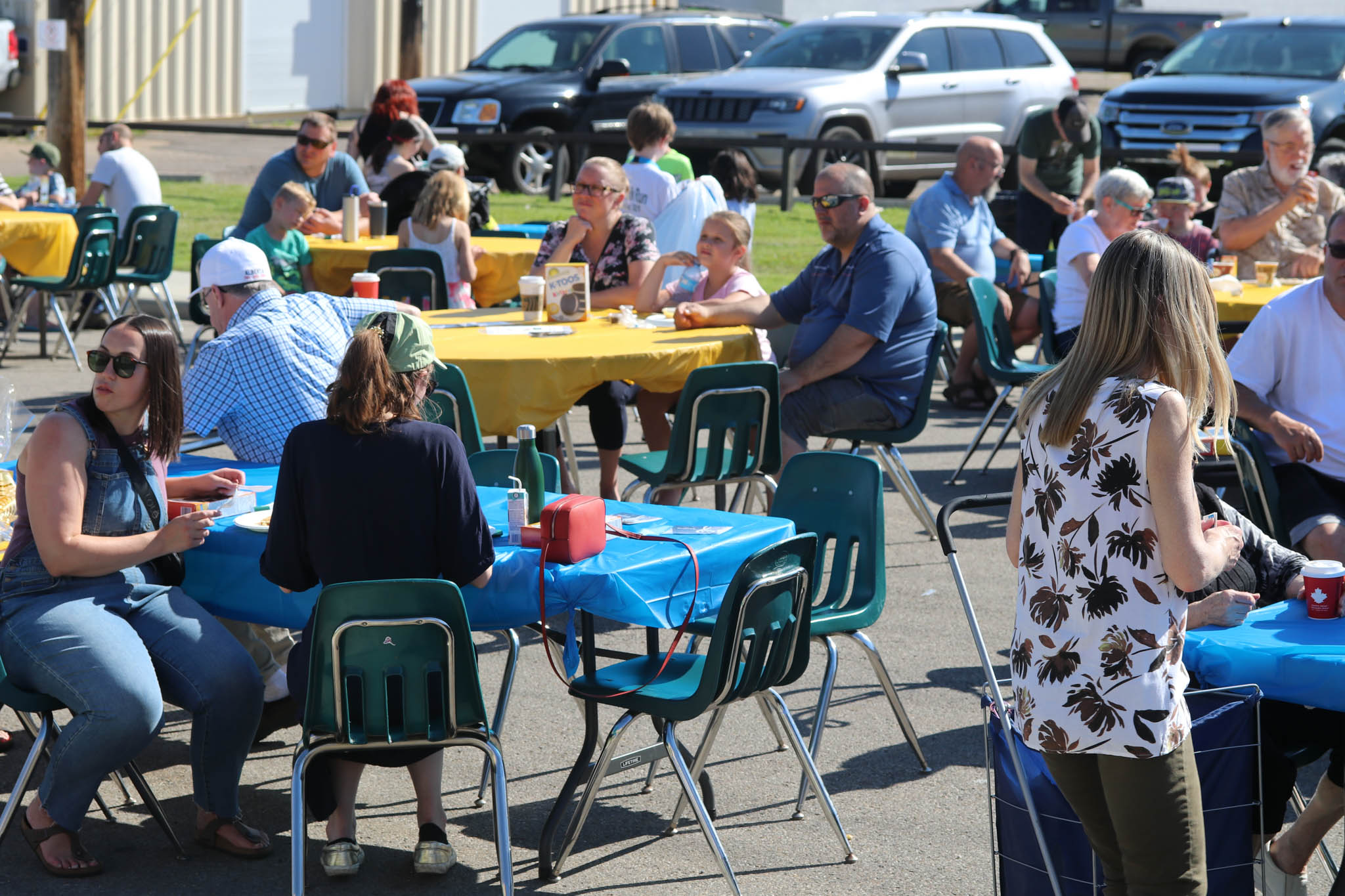 Full tables of people in summer clothes CCA breakfast 