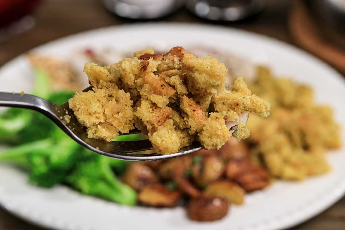 Gluten-free Stove Top Stuffing Close up on a big spoon, meal in background