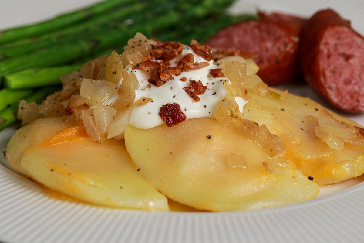 Gluten-free Cheddar Pierogies on dish surrounded by Ukrainian plates and casserole dishes